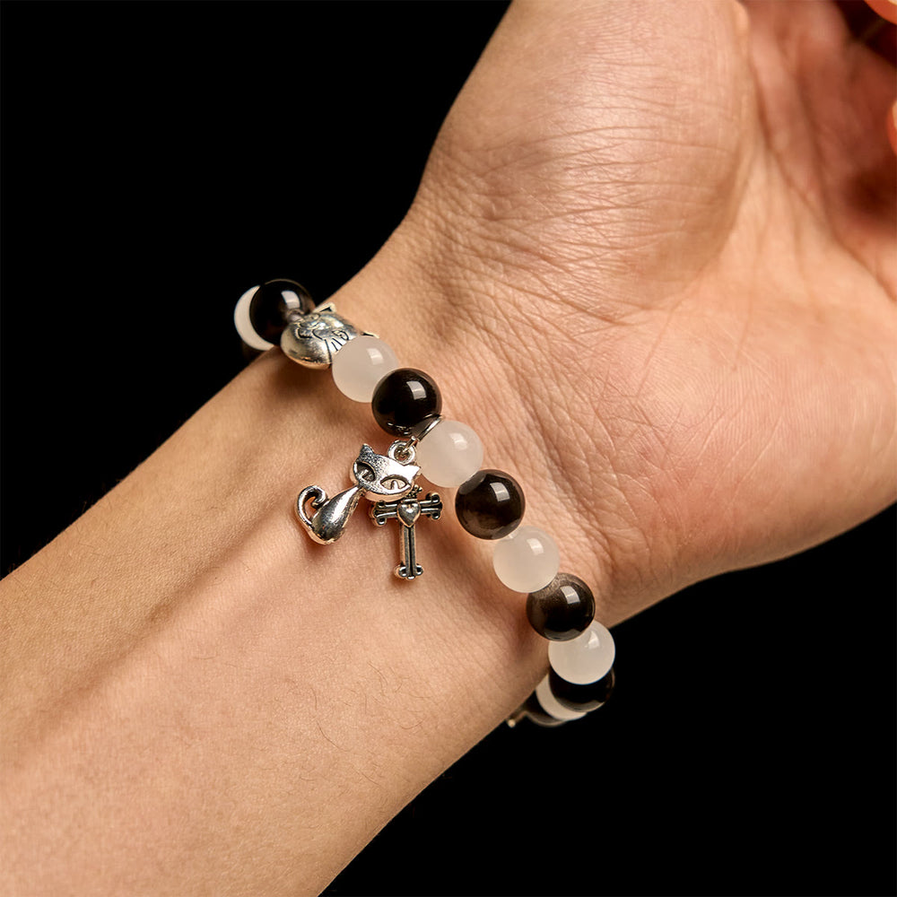 Christianartworkshop Segen Unserer Lieben Frau mit schwarz-weißen Kuh- und Katzenperlen, Tierarmband - image 1