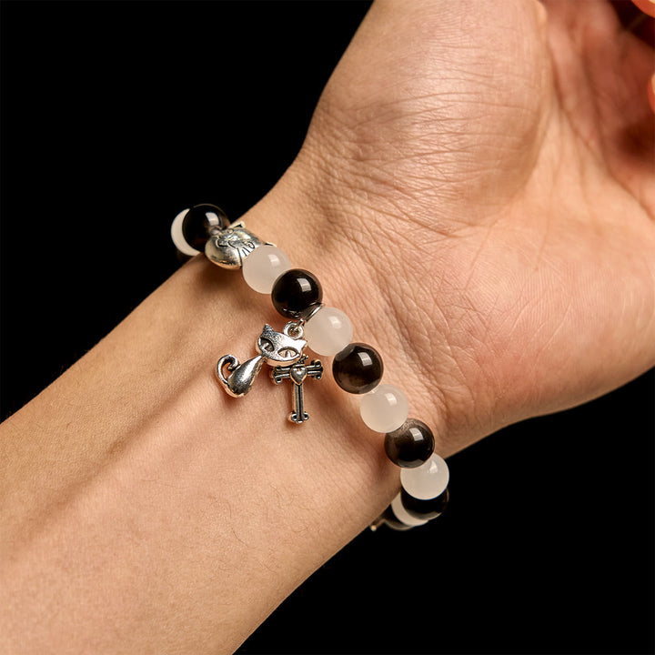 Christianartworkshop Segen Unserer Lieben Frau mit schwarz-weißen Kuh- und Katzenperlen, Tierarmband - image 1