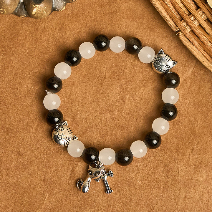 Christianartworkshop Segen Unserer Lieben Frau mit schwarz-weißen Kuh- und Katzenperlen, Tierarmband - image 4