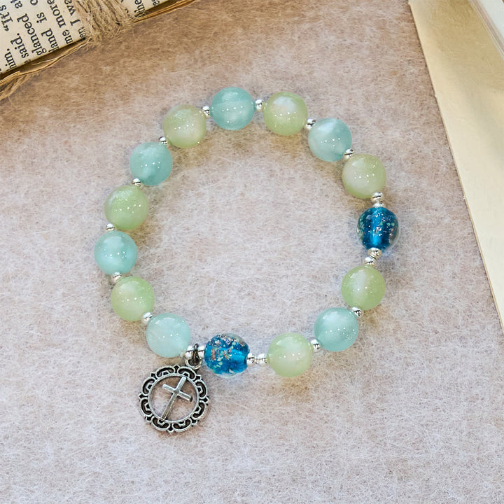 Christianartworkshop UV-wechselndes Glitzerperlenarmband mit verziertem Kreuz: Schimmert in leuchtenden Farben - image 2
