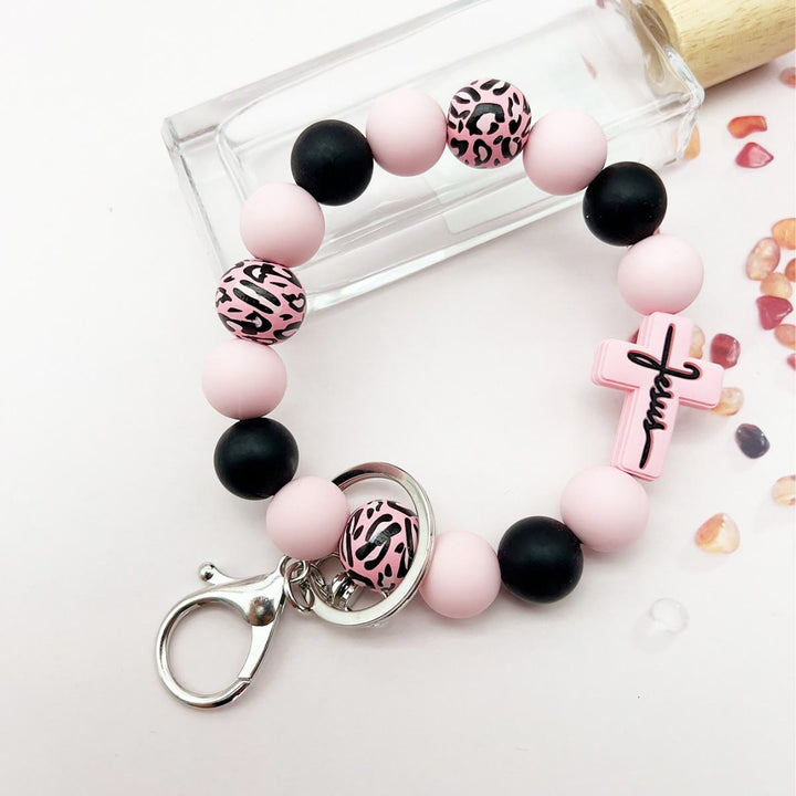 Christianartworkshop Rosenkranz-Schlüsselanhänger mit Silikonkreuz und Holzperlen im Leopardenmuster: Andacht für unterwegs - Rosa - image 3