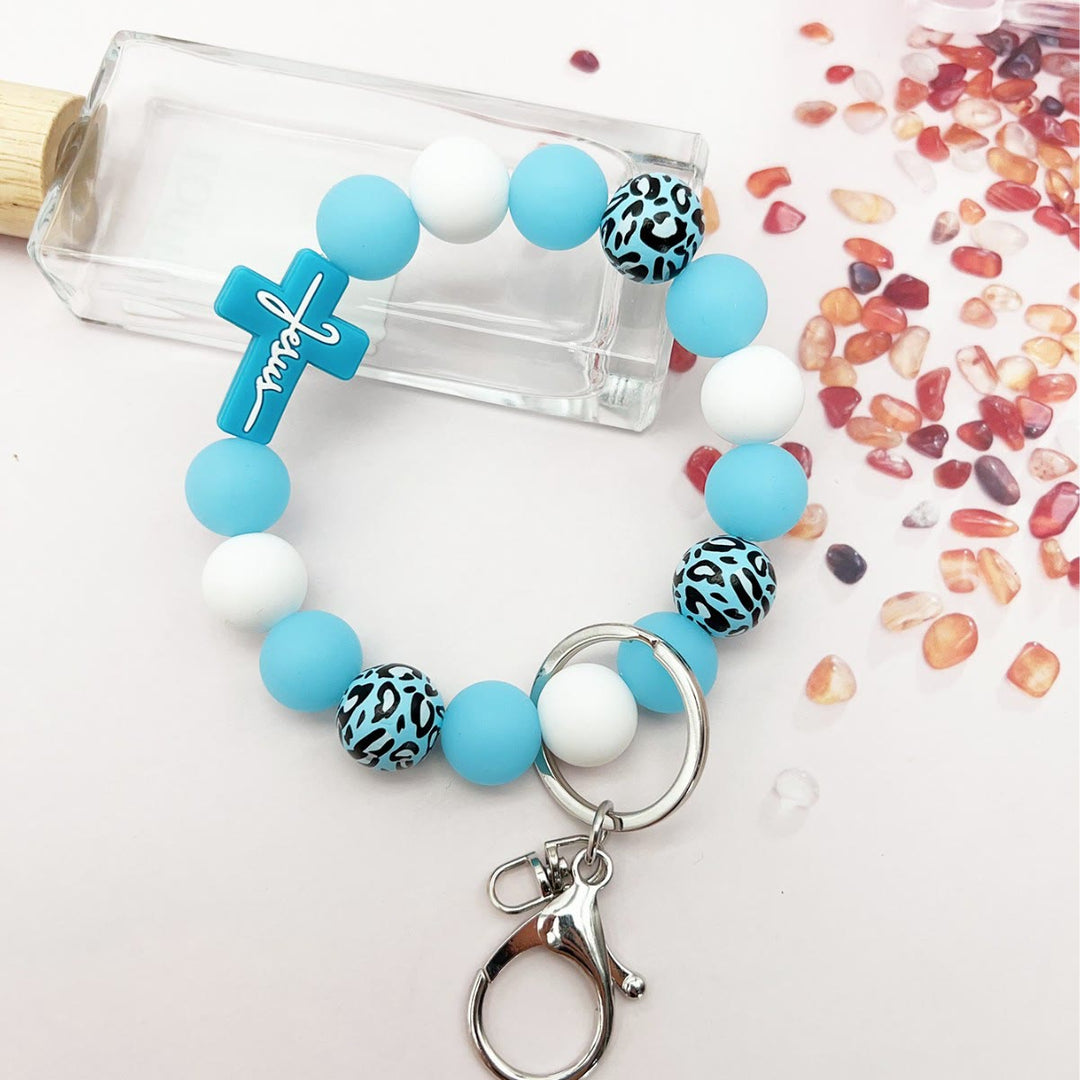 Christianartworkshop Rosenkranz-Schlüsselanhänger mit Silikonkreuz und Holzperlen im Leopardenmuster: Andacht für unterwegs - Blau - image 5