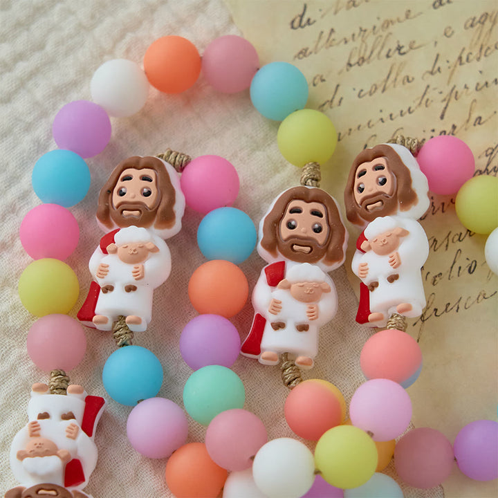 Christianartworkshop Rosenkranz aus pastellfarbenen Silikonperlen mit Jesus-Motiven: Ein Symbol kindlichen Glaubens und göttlicher Freude - image 3