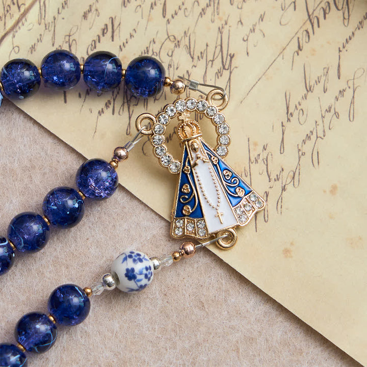 Christianartworkshop Rosenkranz aus tiefblauem, gesprungenem Glas und Porzellanperlen mit einem Mittelstück der Muttergottes von Aparecida - image 5