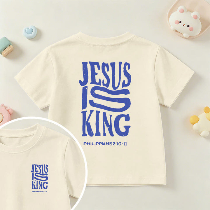 Christianartworkshop „Jesus ist König“ Philipper 2,10-11 Kinder-T-Shirt mit kurzen Ärmeln und auffälligem Aufdruck in abgenutzter, fetter Schrift auf Vorder- und Rückseite - Beige - US/GB/AU 14, EU 170 - image 0