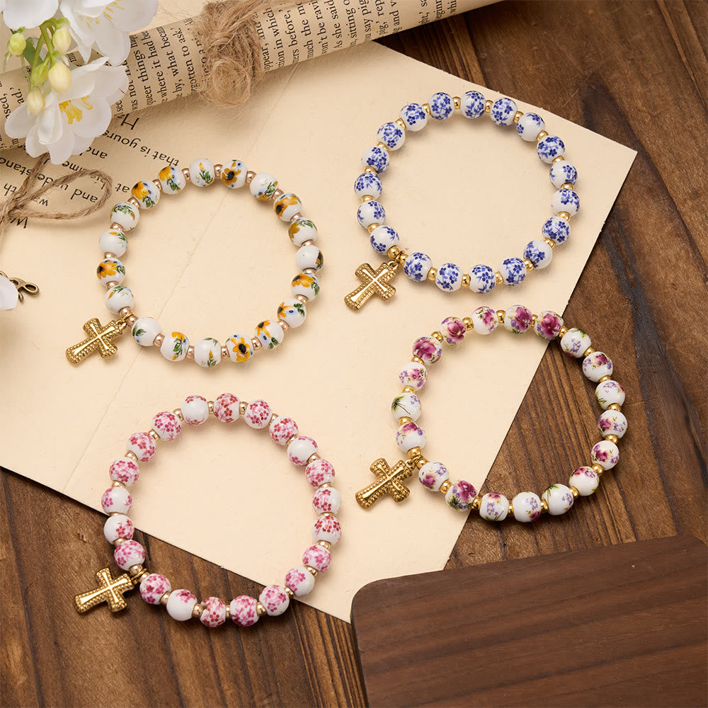 Christianartworkshop Elastisches Armband mit vier floralen Keramikperlen und goldfarbenem Kreuzanhänger: Ein Symbol sanfter himmlischer Gnade - image 1