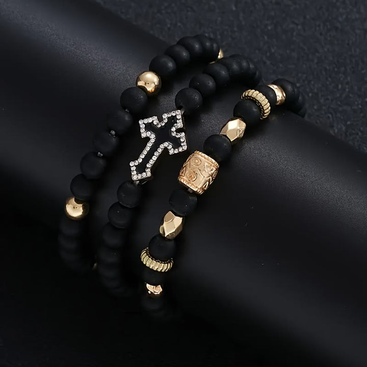 Christianartworkshop Mehrlagiges, dehnbares Armband aus mattschwarzen Steinperlen mit Zirkonia-Kreuz und gravierten Goldzwischenstücken - image 3