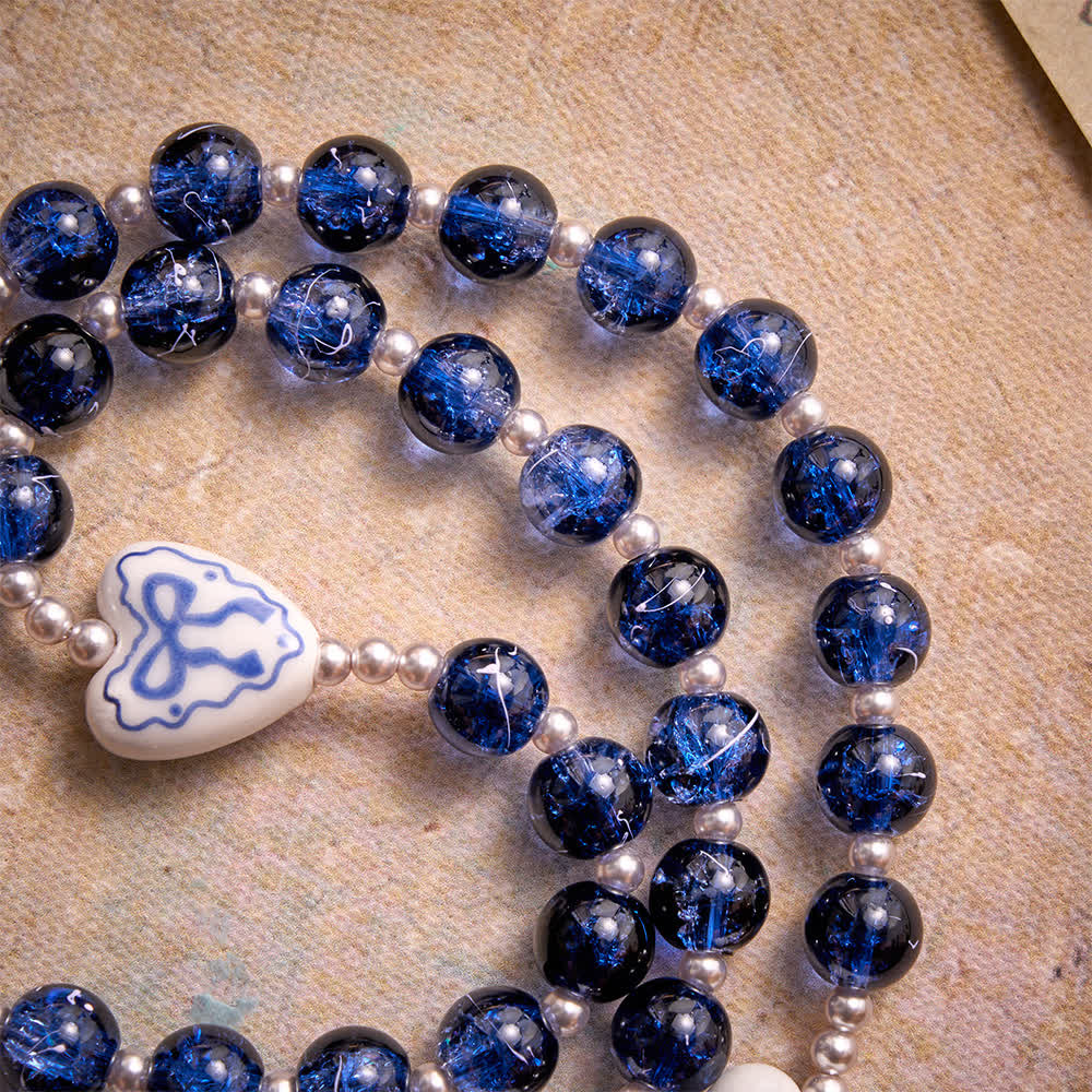 Christianartworkshop Rosenkranz aus blauem Crackle-Glas mit Keramikherz-Schleifenperlen und Marienmedaille - image 8