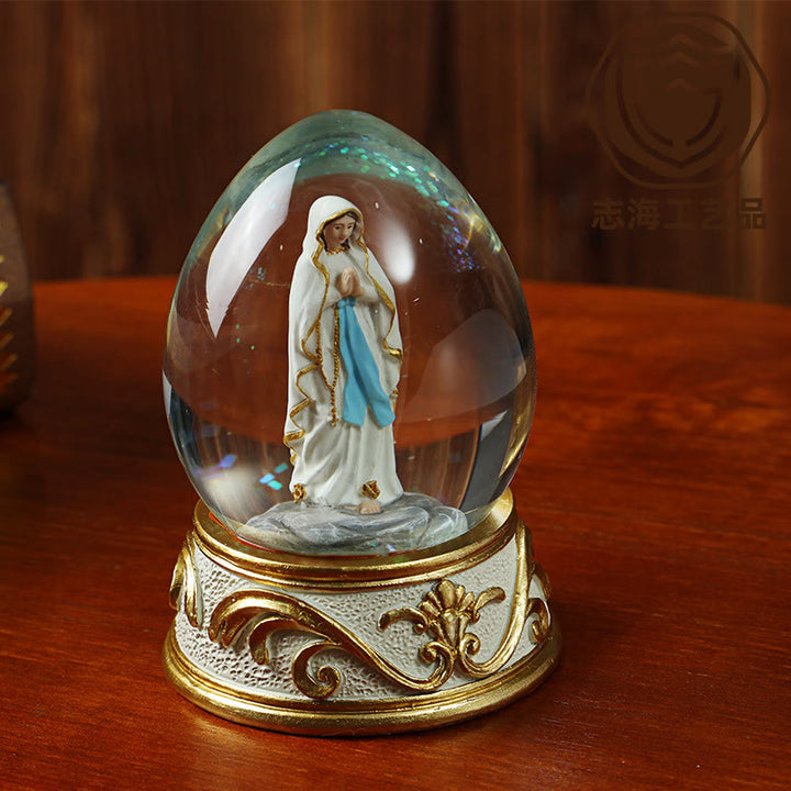 Christianartworkshop Glitzernde Schneekugel in Eiform mit betender Madonna-Statue: Symbol reiner himmlischer Bitte - image 2