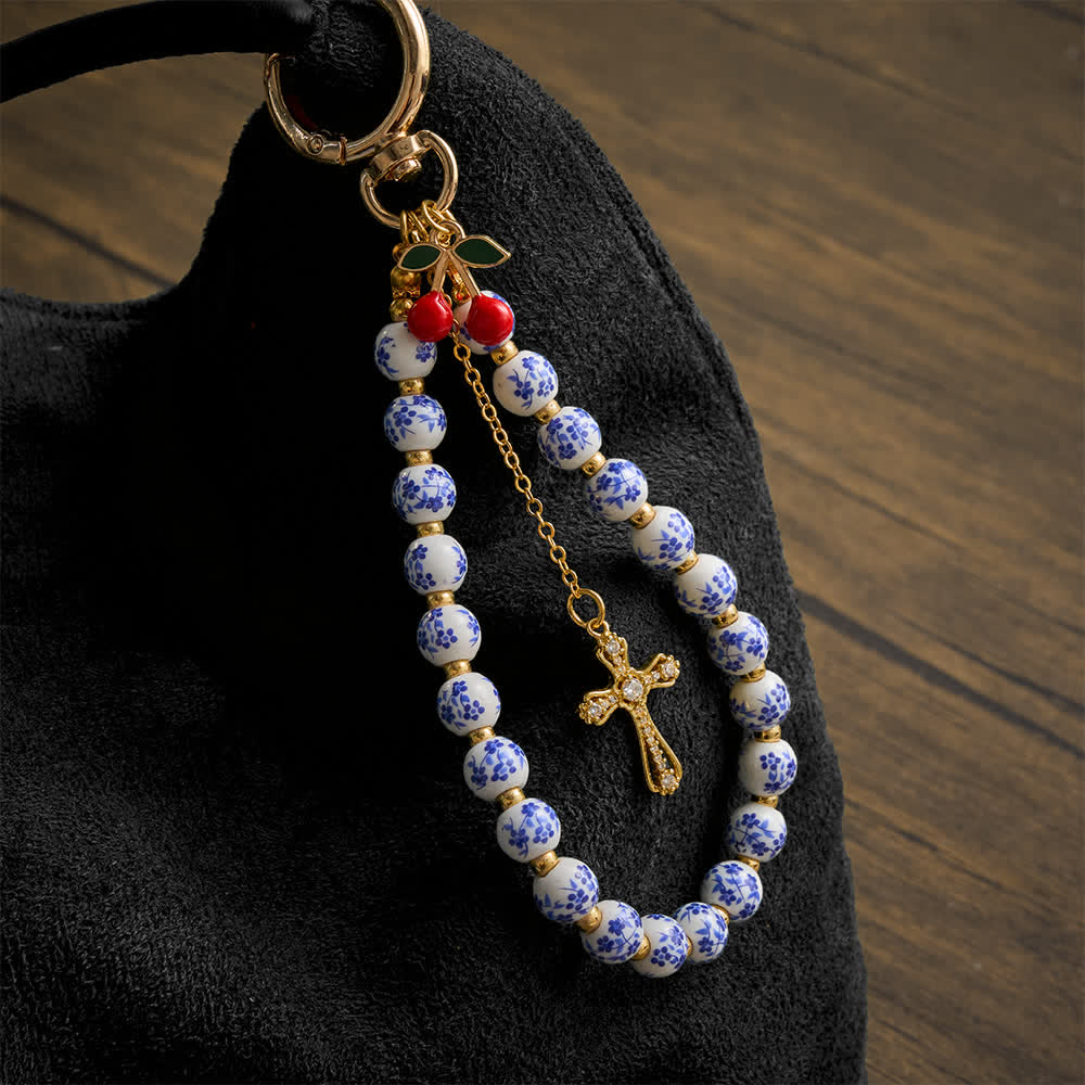Christianartworkshop Taschenanhänger mit Kirschmotiv aus Porzellanperlen und Schmuckkreuz: Symbol sanfter himmlischer Gnade - Kirsch-Anhänger aus Keramik mit Blumenmuster - image 0